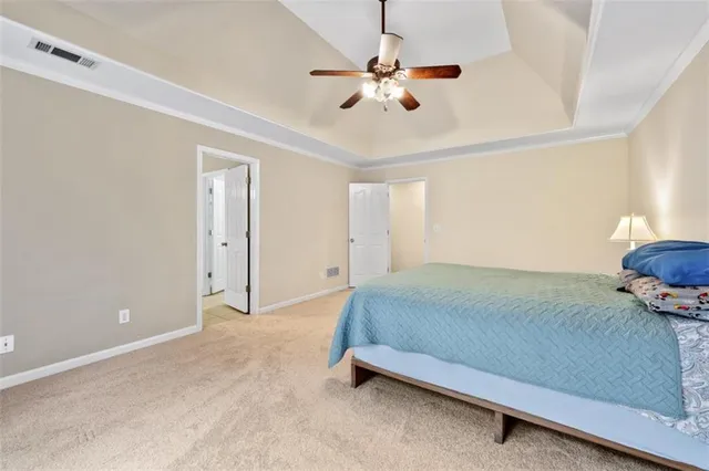 a bedroom with a bed and a ceiling fan
