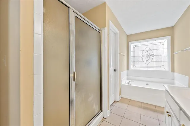 a bathroom with a bathtub and a shower