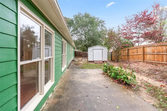 a front view of a house with a garden and yard