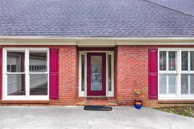 a front view of a brick house with a outdoor space