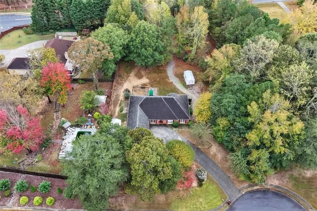 an aerial view of a house with a yard