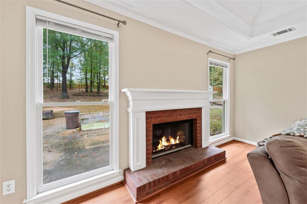 2985 Ashton Pointe Circle Dacula, GA 30019 - Photo 10 of 47 a living room with furniture and a fireplace