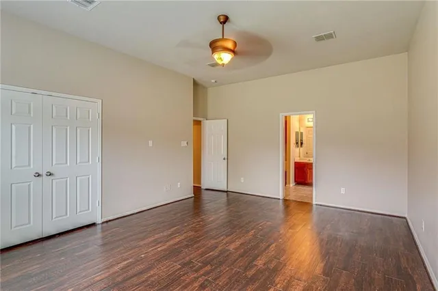 a view of an empty room with wooden floor