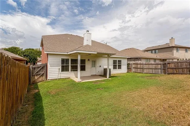 a front view of a house with a garden and yard
