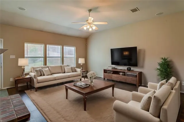 a living room with furniture and a flat screen tv