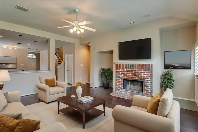 a living room with furniture fireplace and flat screen tv