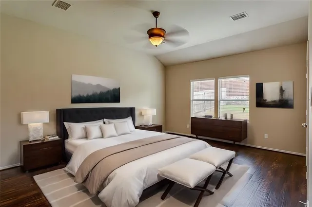 a bedroom with a bed and wooden floor