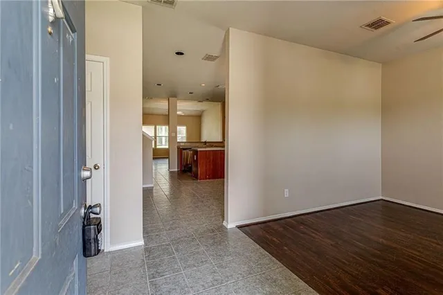 a view of kitchen and hall with wooden floor
