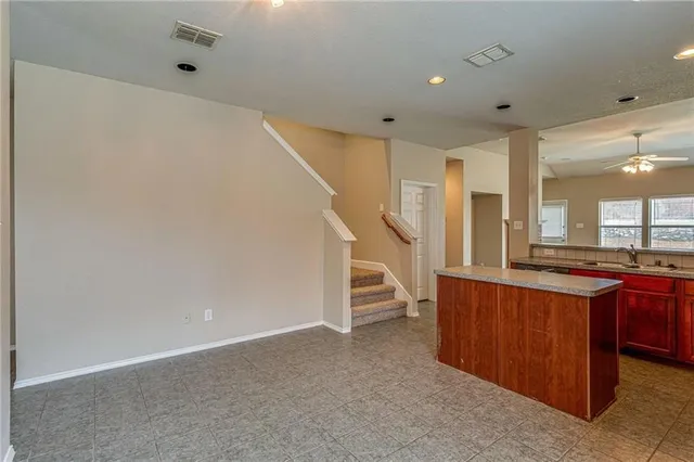 a view of a kitchen with furniture and staircase