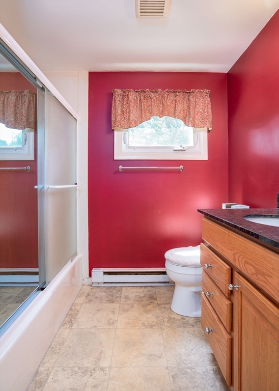 60 Saffron Circle Springfield, MA 01129 - Photo 17 of 37 a bathroom with a granite countertop toilet a sink and a shower