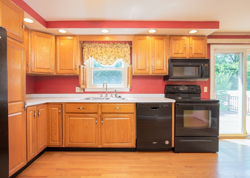 60 Saffron Circle Springfield, MA 01129 - Photo 6 of 37 a kitchen with stainless steel appliances granite countertop a stove a sink and a microwave