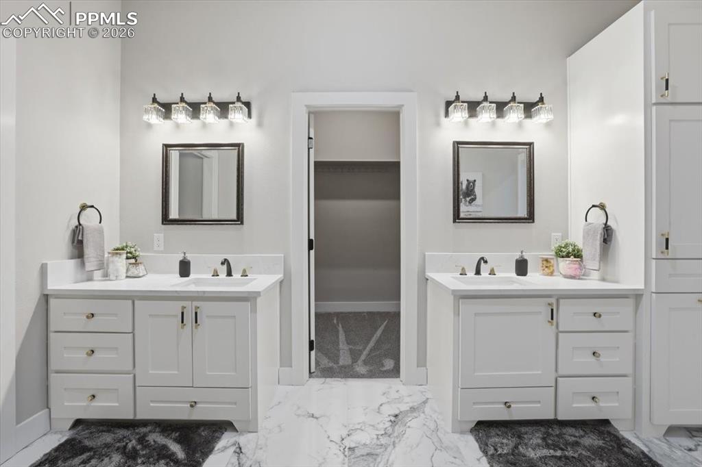 15755 Fool's Gold Lane Colorado Springs, CO 80921 - Photo 21 of 50 a bathroom with a sink vanity and mirror