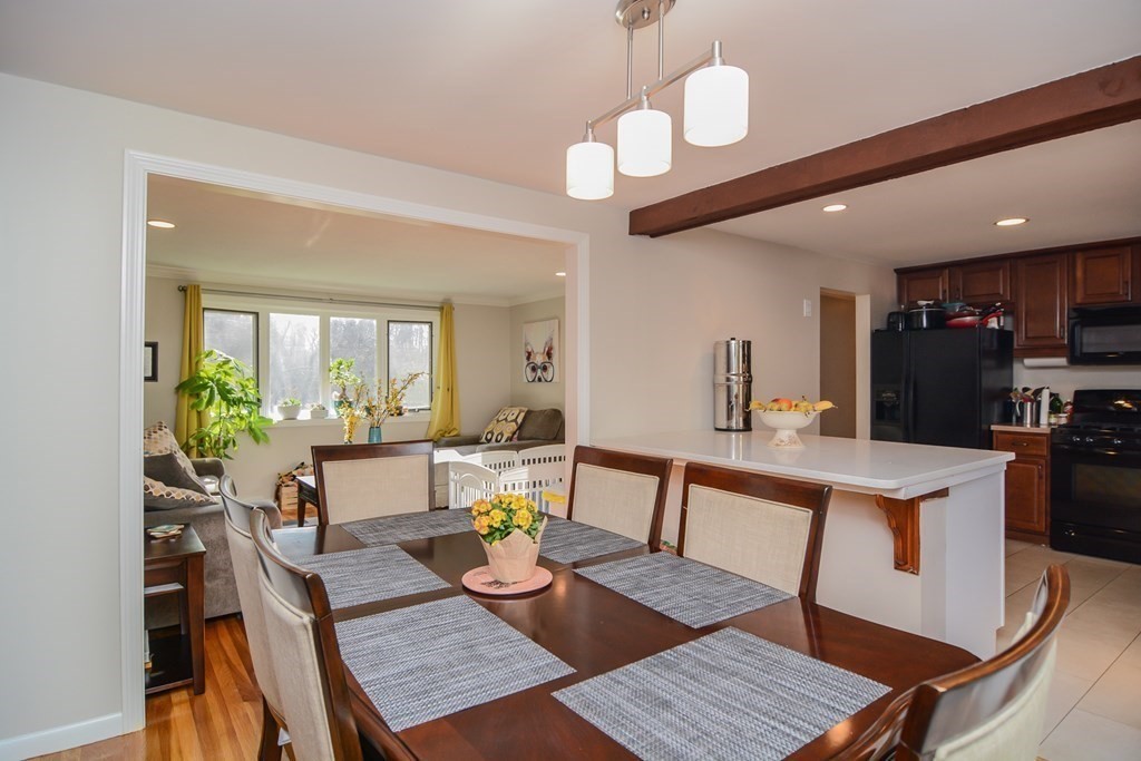 94 West Street Medway, MA 02053 - Photo 13 of 41 a view of a dining room with furniture window and wooden floor