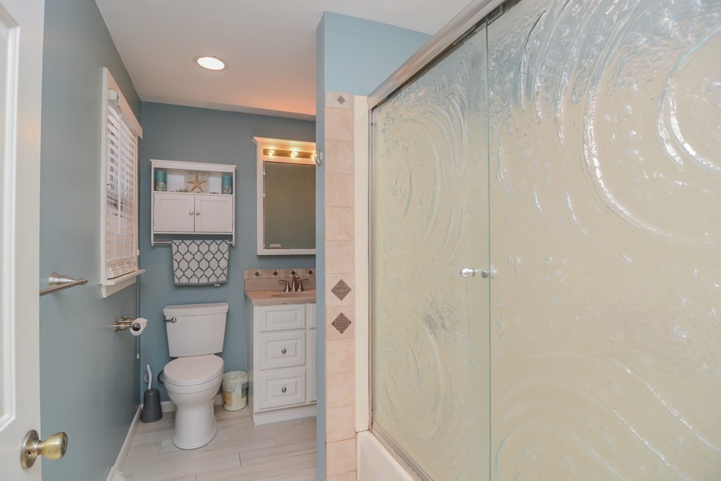 94 West Street Medway, MA 02053 - Photo 17 of 41 a bathroom with a toilet a sink and mirror