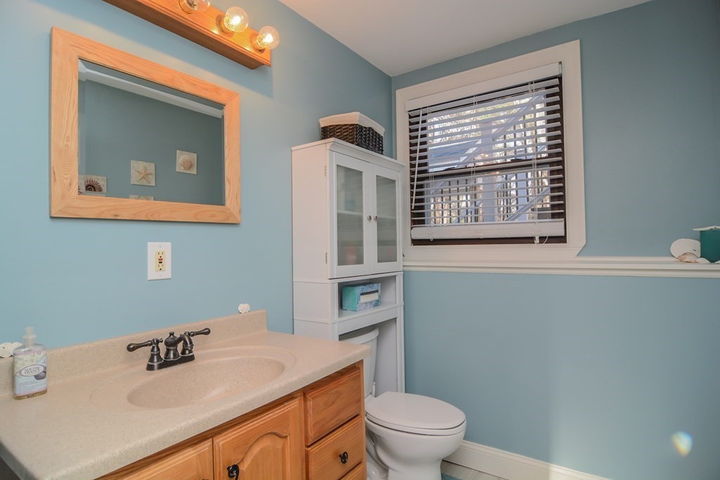 94 West Street Medway, MA 02053 - Photo 18 of 41 a bathroom with a sink a toilet and a mirror