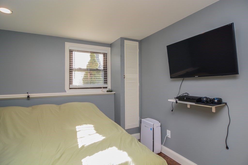 94 West Street Medway, MA 02053 - Photo 21 of 41 a living room with a flat screen tv and a window