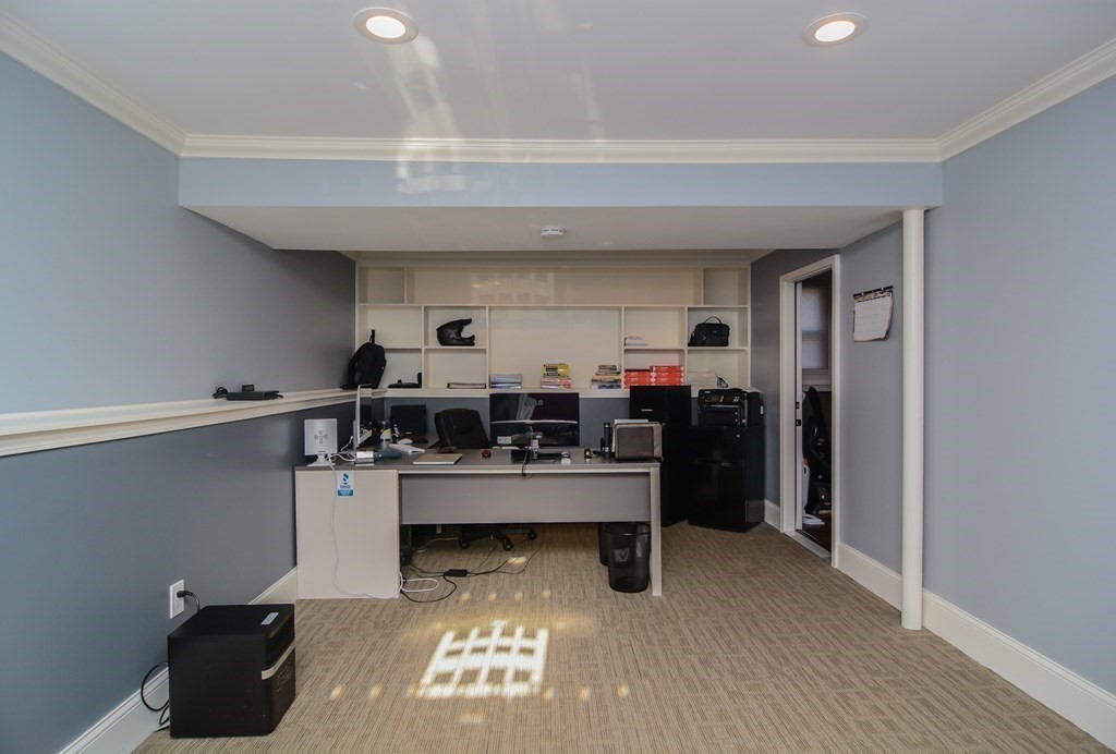 94 West Street Medway, MA 02053 - Photo 22 of 41 a view of a workspace with furniture and a window