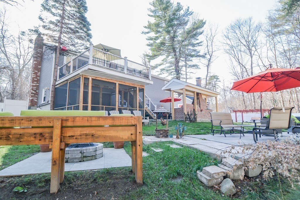 94 West Street Medway, MA 02053 - Photo 27 of 41 a front view of a house with a yard table and chairs