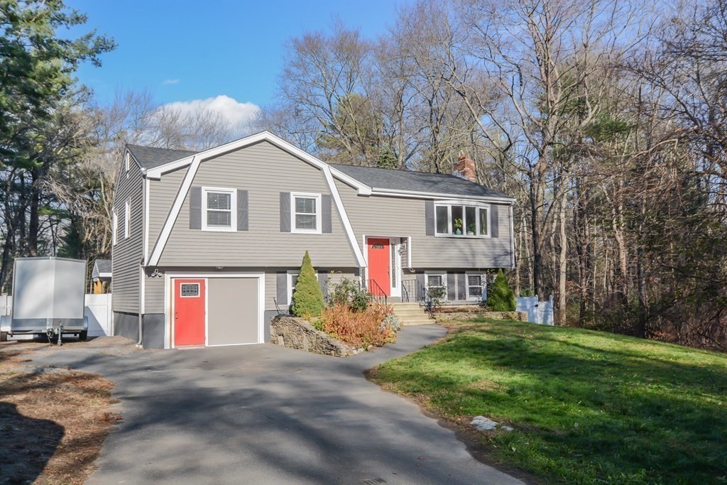94 West Street Medway, MA 02053 - Photo 3 of 41 a front view of house with yard and trees in the background