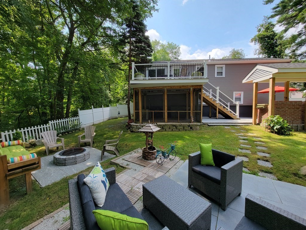 94 West Street Medway, MA 02053 - Photo 33 of 41 a view of a house with backyard sitting area and garden