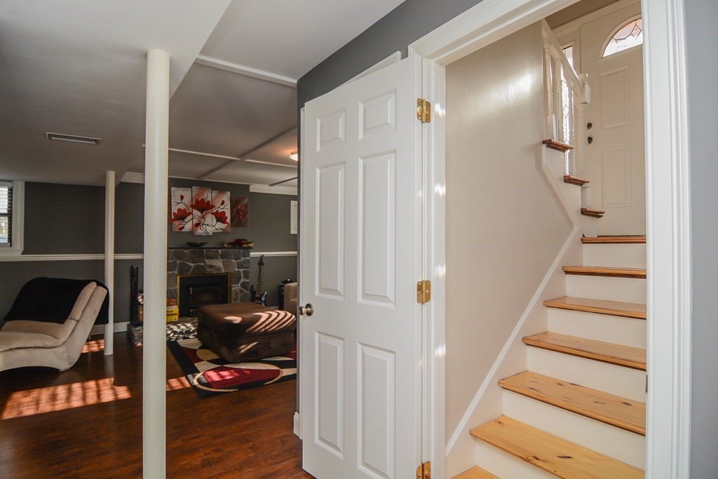 94 West Street Medway, MA 02053 - Photo 39 of 41 a view of a livingroom with wooden floor and a ceiling fan