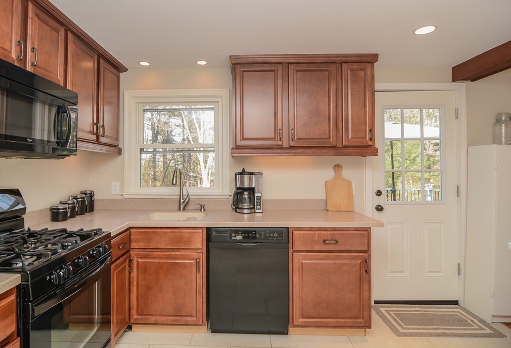 94 West Street Medway, MA 02053 - Photo 7 of 41 a kitchen with stainless steel appliances granite countertop a stove a sink dishwasher and a microwave oven with large cabinets