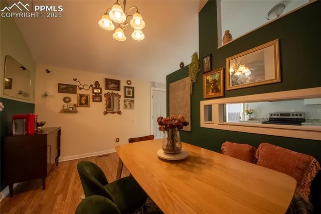 a view of a dining room with furniture and chandelier