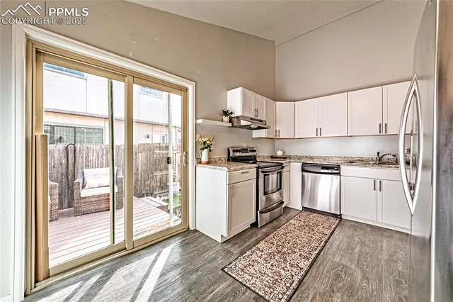 a kitchen with white cabinets and white appliances