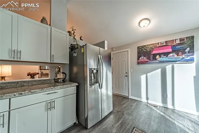 a kitchen with stainless steel appliances granite countertop a refrigerator and a stove