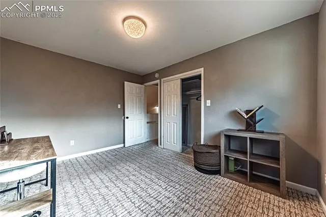 a spacious bedroom with a bed and a table in it