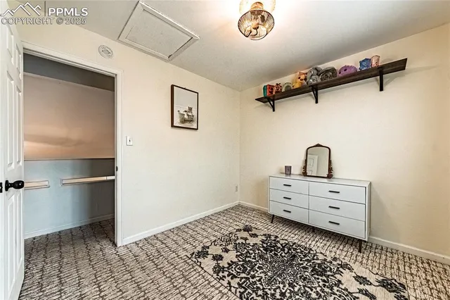 a room with a walk in closet and a mirror