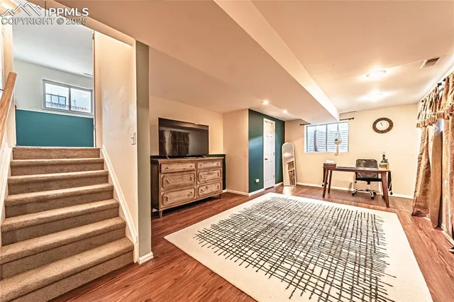 a bedroom with furniture and a wooden floor
