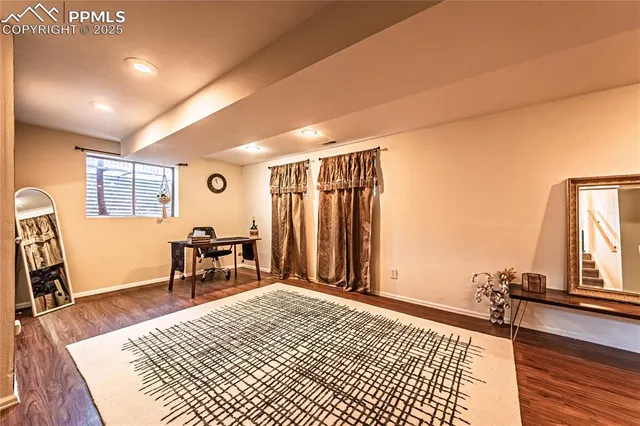 a bedroom with furniture window and wooden floor