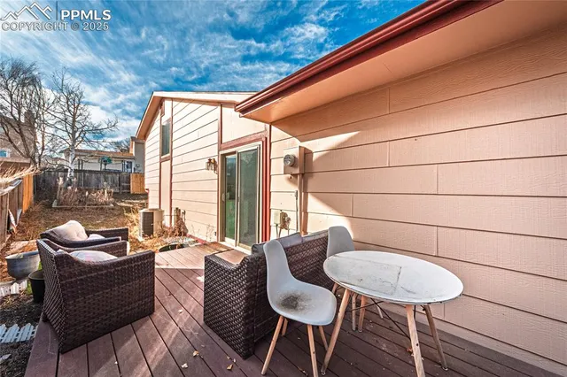 a balcony with a couch and wooden floor