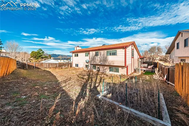 a backyard of a house with table and chairs