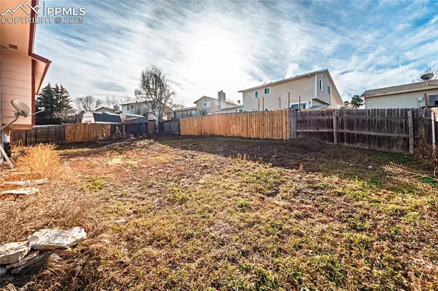 a backyard of a house with outdoor seating