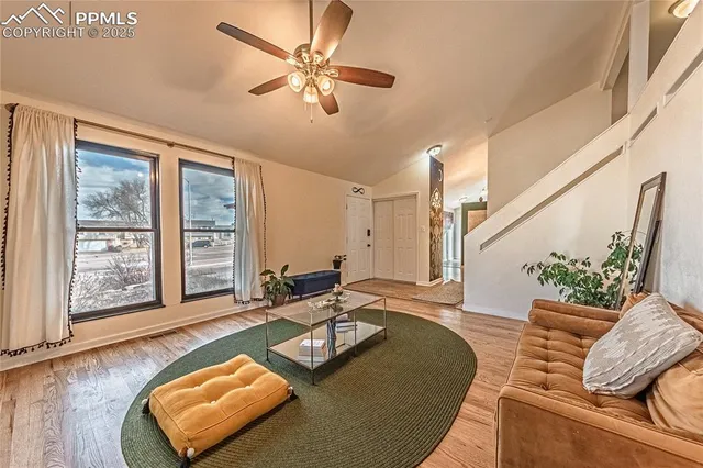 a living room with furniture and a large window
