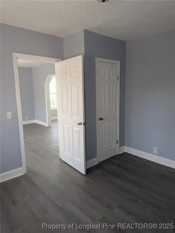 a view of a room with wooden floor