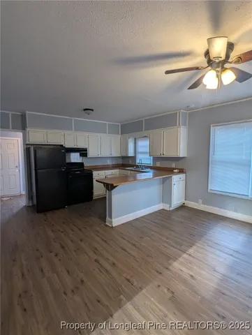 a view of kitchen with wooden floor