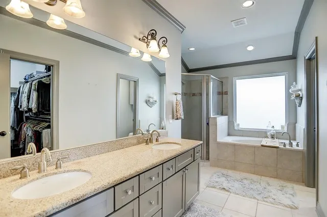 a bathroom with a granite countertop sink a large mirror and a shower