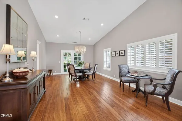 a view of a dining room with furniture and chandelier