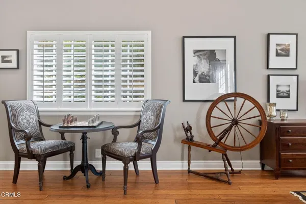 a dining room with furniture a chandelier and wooden floor