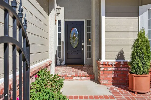 a living room with furniture a chandelier and a fireplace