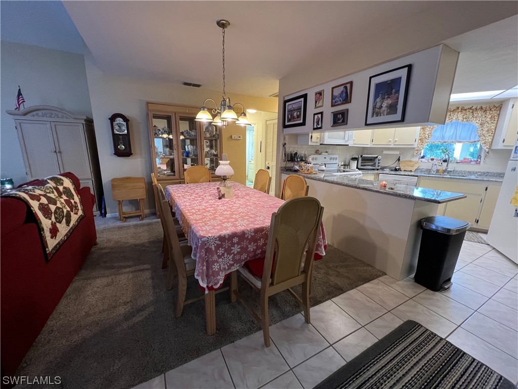 3 Regency Court Lehigh Acres, FL 33936 - Photo 13 of 27 a dining hall with a dining table and chairs