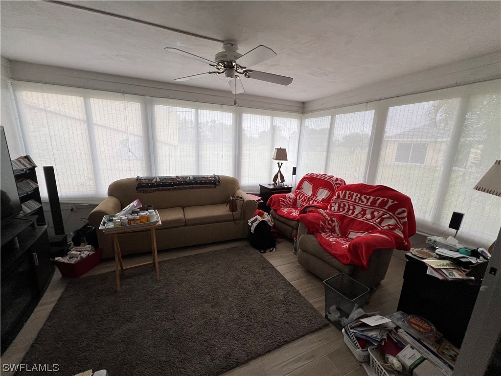 3 Regency Court Lehigh Acres, FL 33936 - Photo 17 of 27 a living room with furniture a flat screen tv and a window