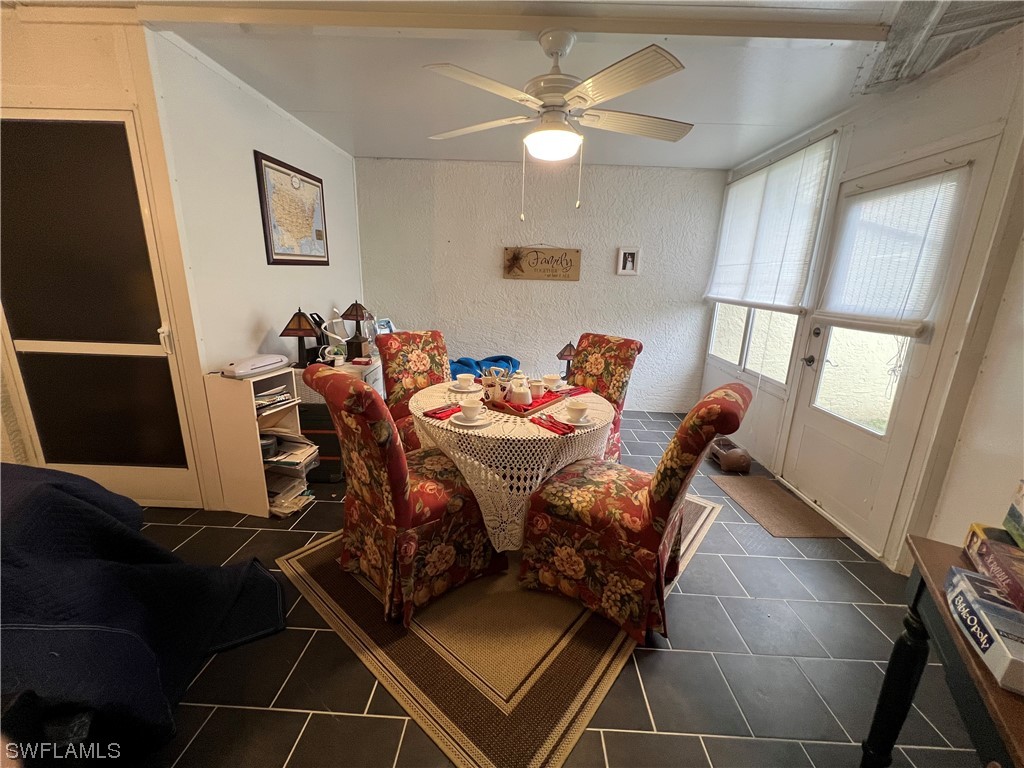 3 Regency Court Lehigh Acres, FL 33936 - Photo 18 of 27 a view of a dining room with furniture and a chandelier