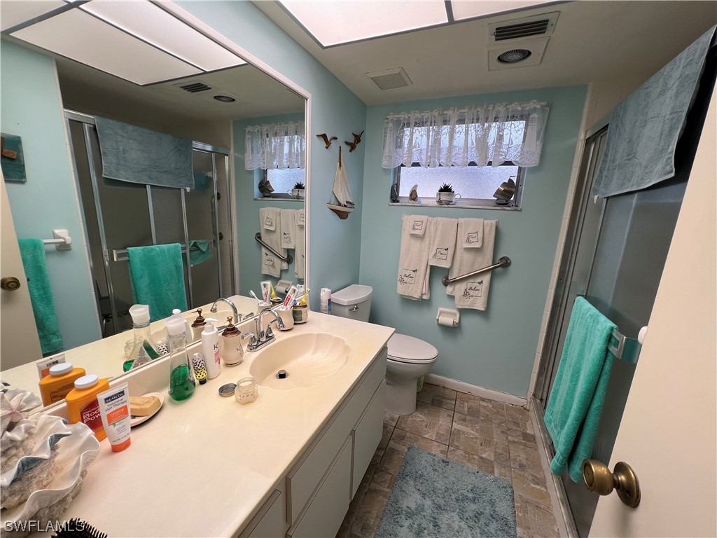 3 Regency Court Lehigh Acres, FL 33936 - Photo 20 of 27 a spacious bathroom with sink and mirror with bathtub