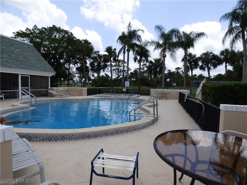 3 Regency Court Lehigh Acres, FL 33936 - Photo 27 of 27 a view of a swimming pool with lounge chairs