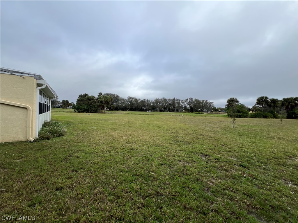 3 Regency Court Lehigh Acres, FL 33936 - Photo 4 of 27 a view of a lake with houses in back