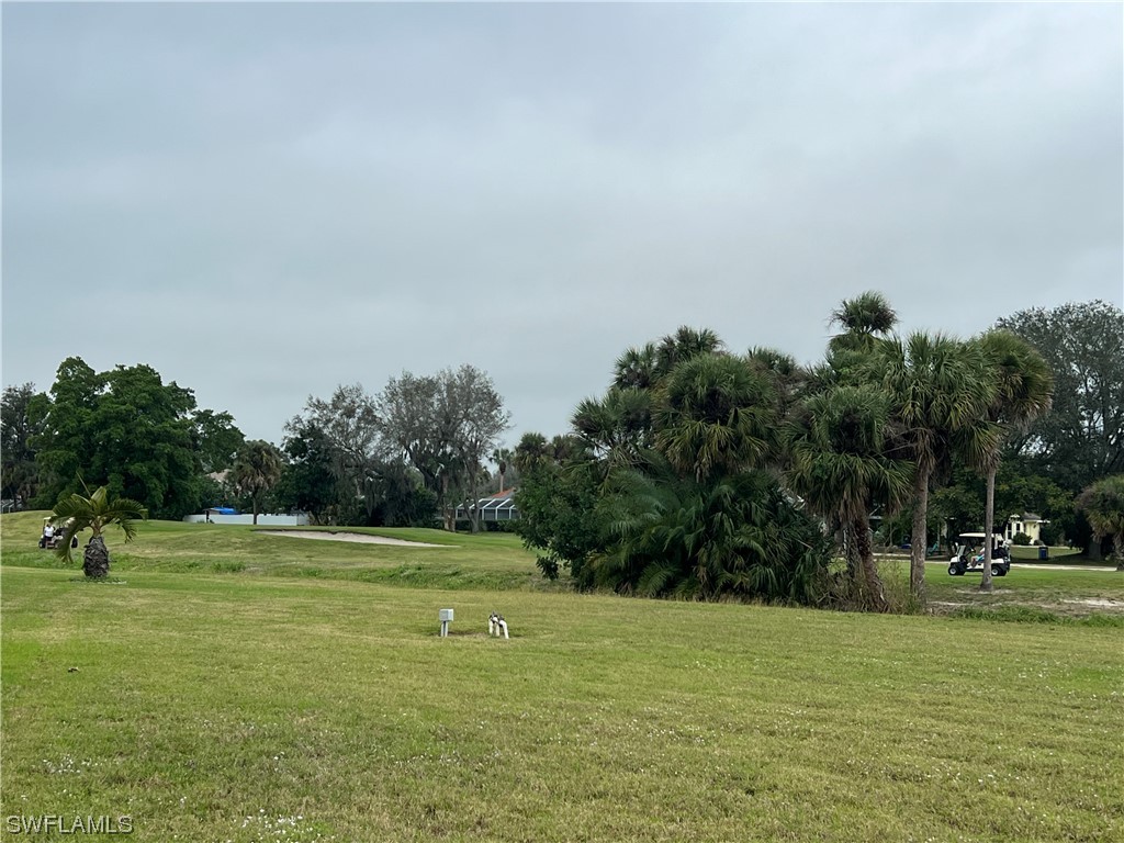 3 Regency Court Lehigh Acres, FL 33936 - Photo 5 of 27 a view of a golf course with a lake